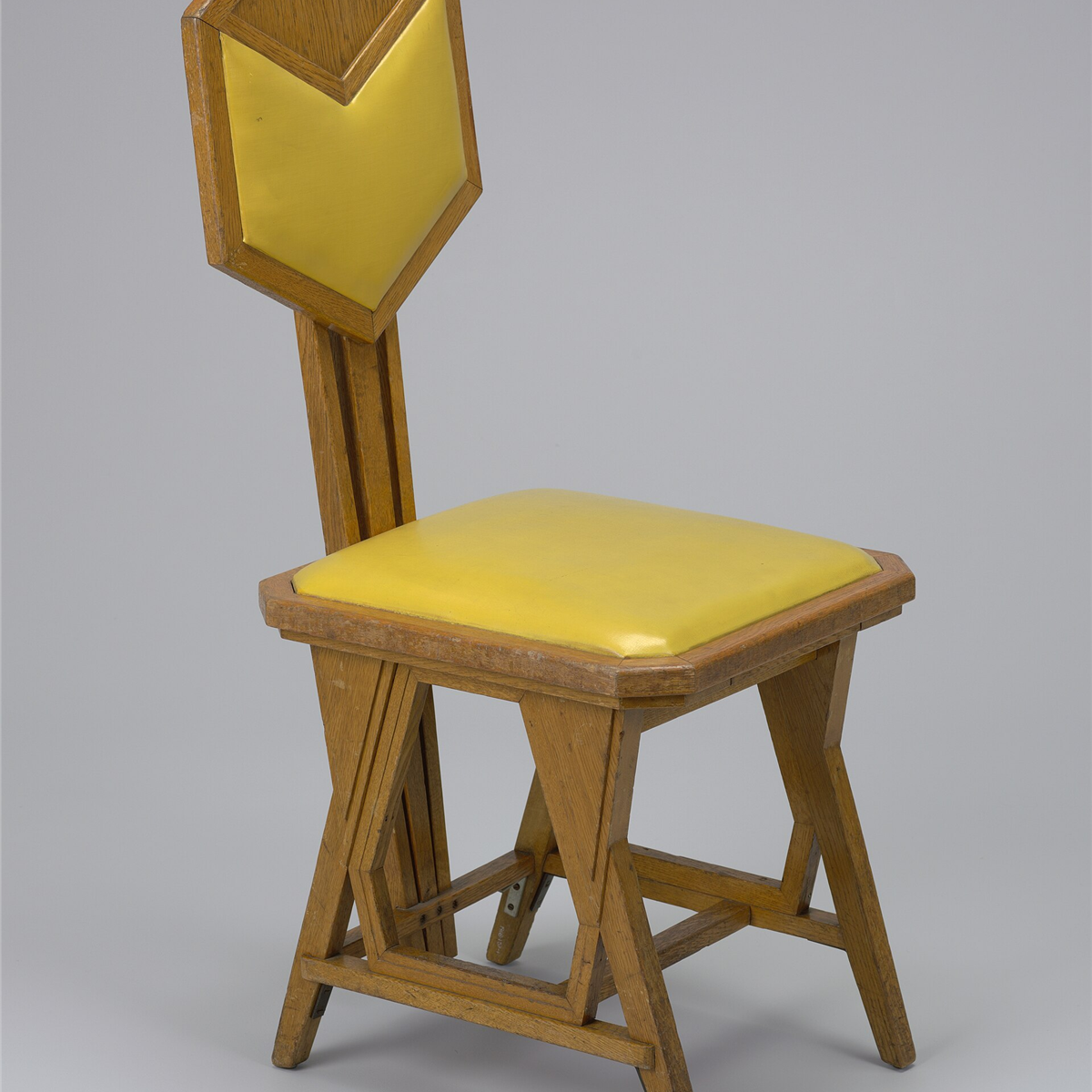 Black cane peacock accent chair with a tall fan back and plush seat